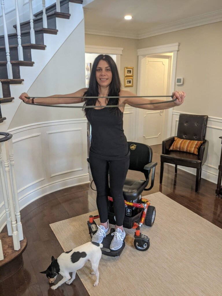 Anna Giannakouros Using An Exercise Band with her Golden LiteRider Envy Power Chair