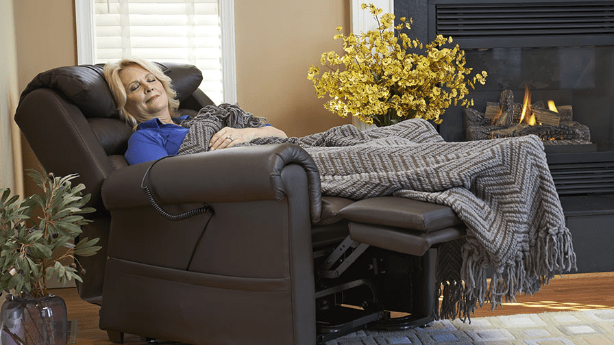 Woman Sleeping in Golden Relaxer Power Lift Chair Recliner By Fireplace