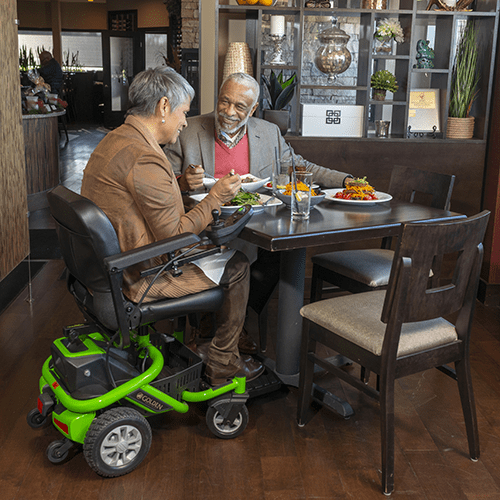 Couple at Restaurant with a Golden Technologies LiteRider Envy Power Wheelchair